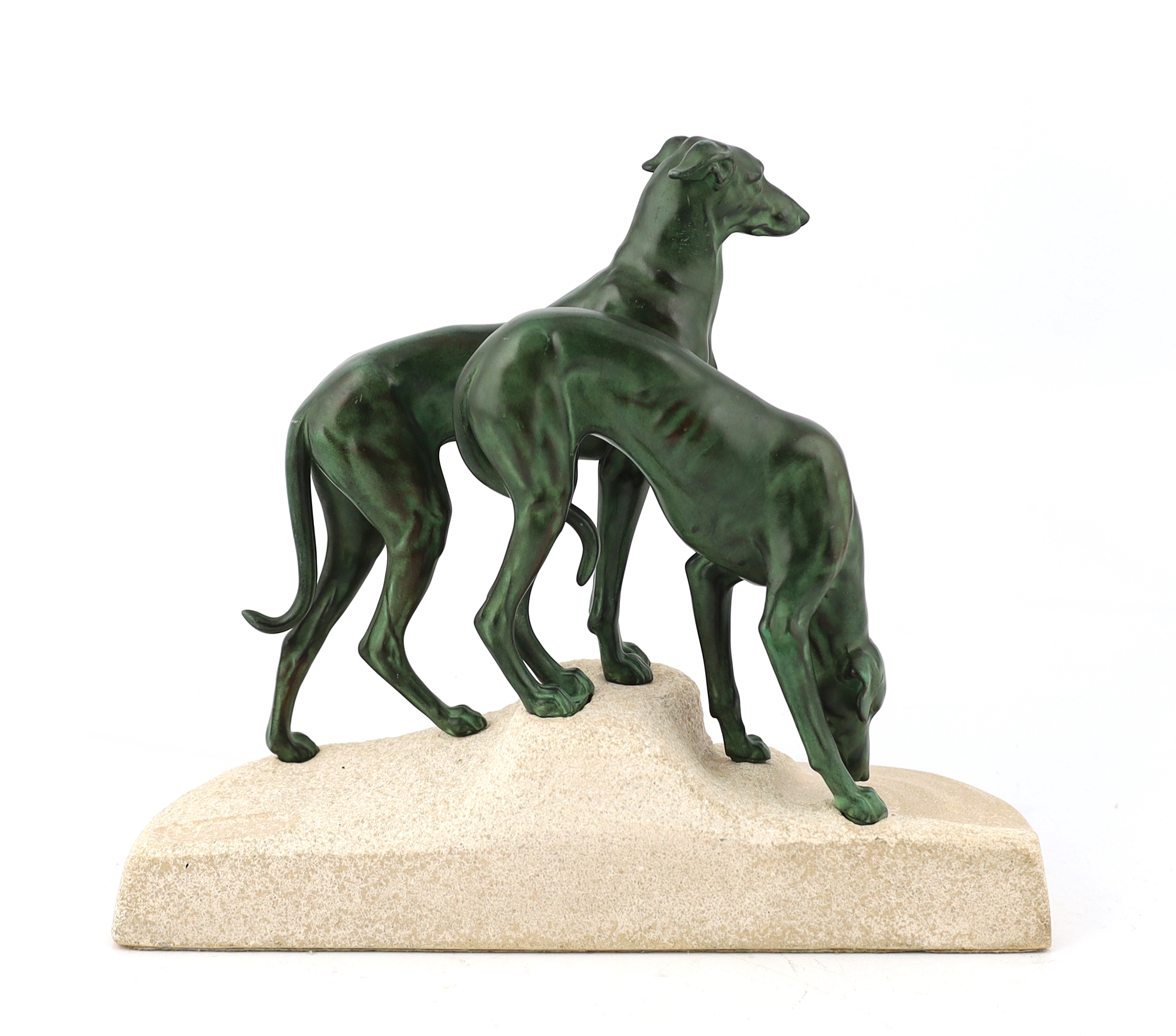Masson, a French Art Deco spelter and composition stone group of two hounds watering, signed in the base, 32cm long, 12cm deep, 28cm high